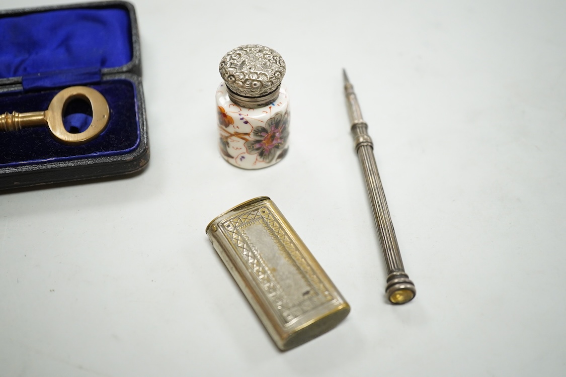 A collection of sundry items to include a large cased key, novelty lighter in the form of a shoe and a citrine set propelling pencil